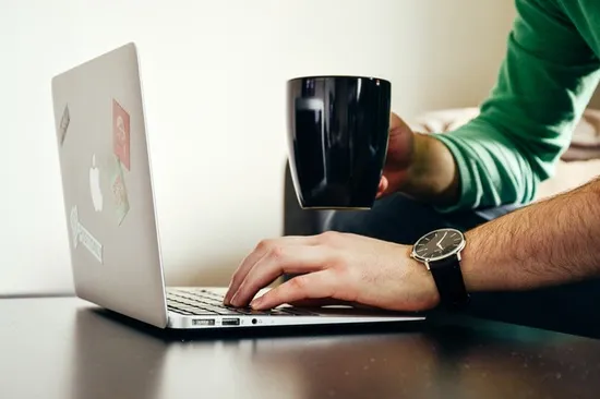 male on laptop taking surveys for money